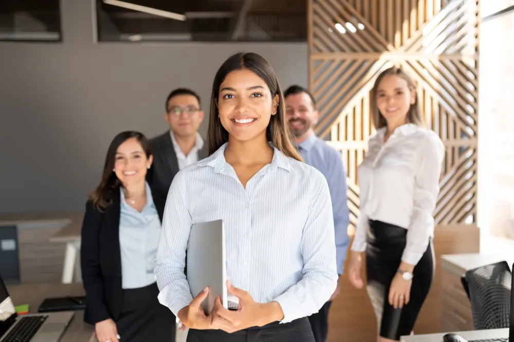 Smiling professionals standing in a modern office.