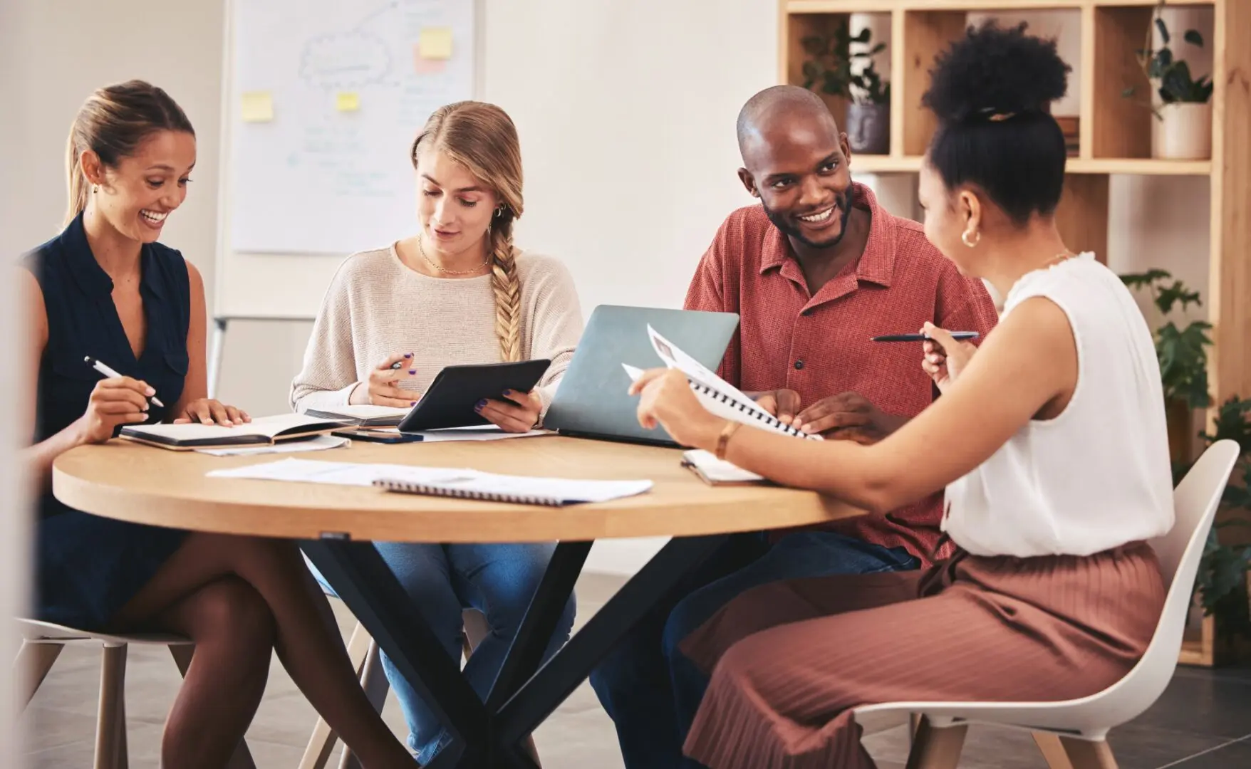 Four people collaborating at a round table.