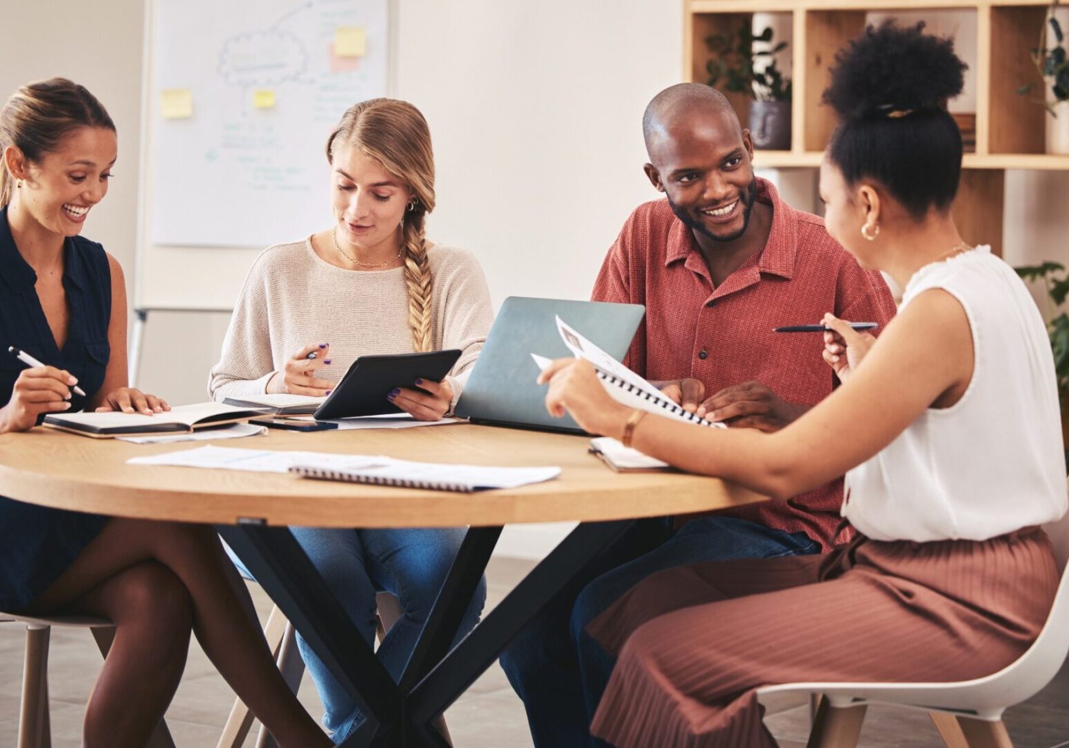 Four people collaborating at a round table.